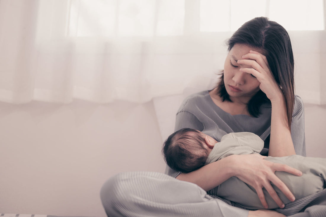 Tired Mother Suffering from experiencing postnatal depression.He
