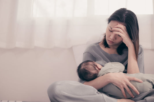 Tired Mother Suffering from experiencing postnatal depression.He