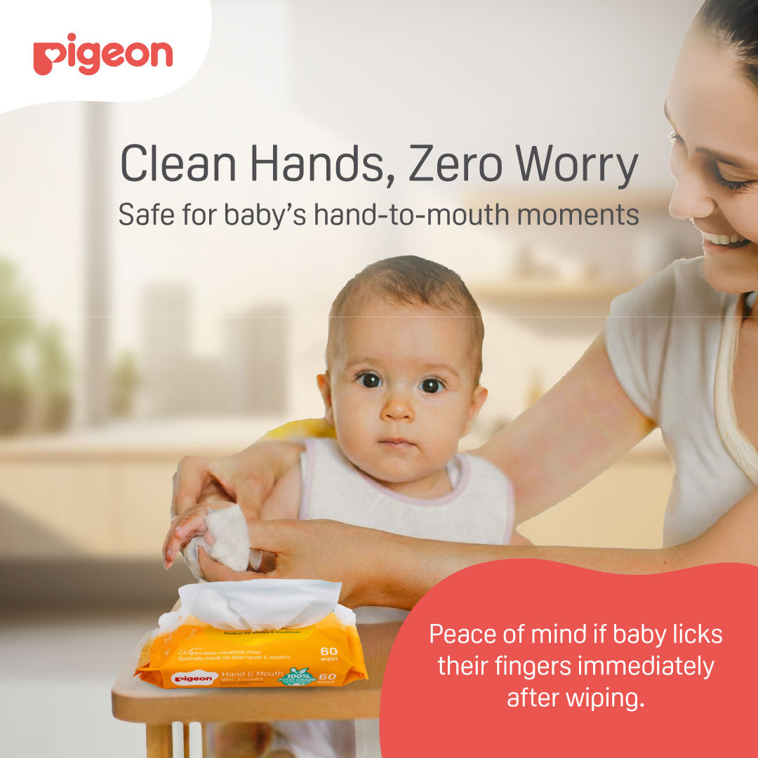 Parent wiping sticky food residue from baby's fingers using a Pigeon hand & Mouth 100% food-grade wet tissue.