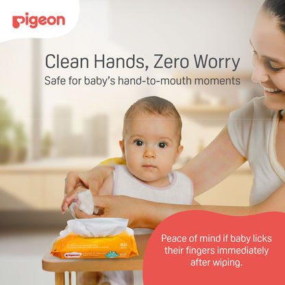 Parent wiping sticky food residue from baby's fingers using a Pigeon hand & Mouth 100% food-grade wet tissue.